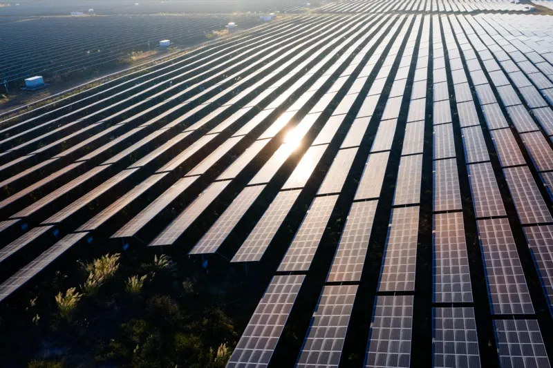 Wide view of a ground-mounted solar farm stretching across open land